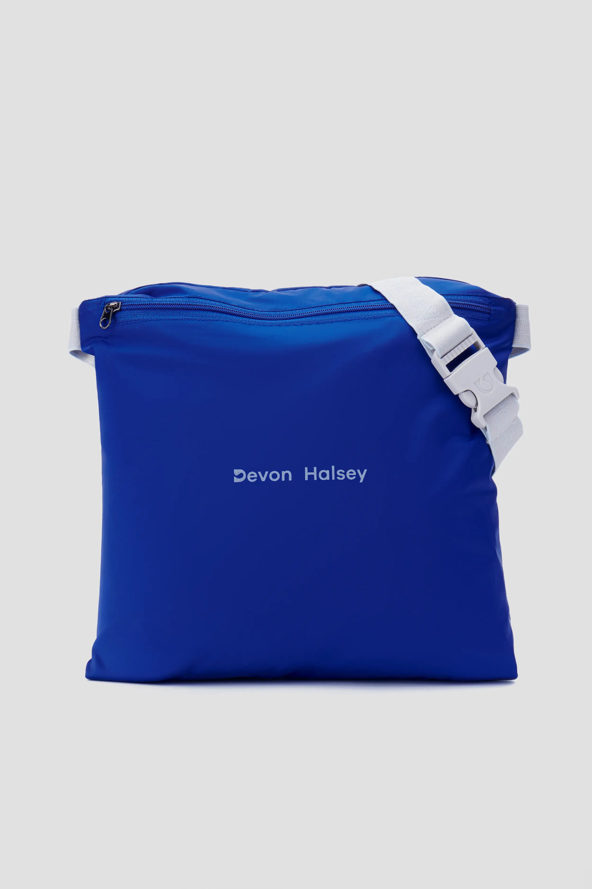 Blue bag with 'Devon Halsey' branding on a light gray background