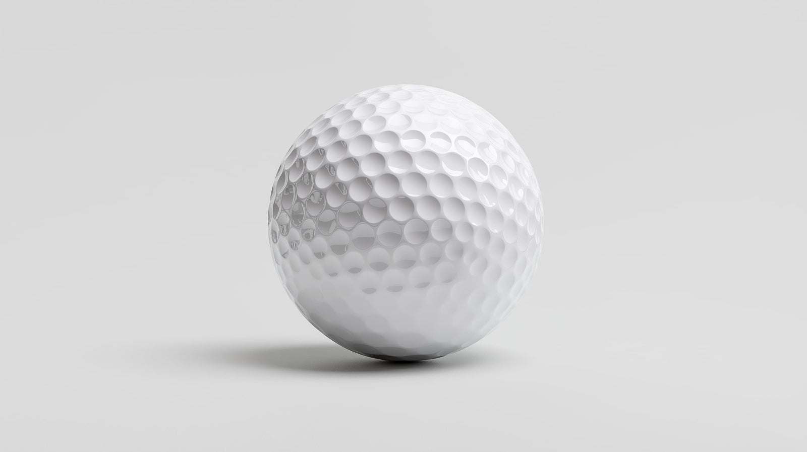 White golf ball on a light gray background