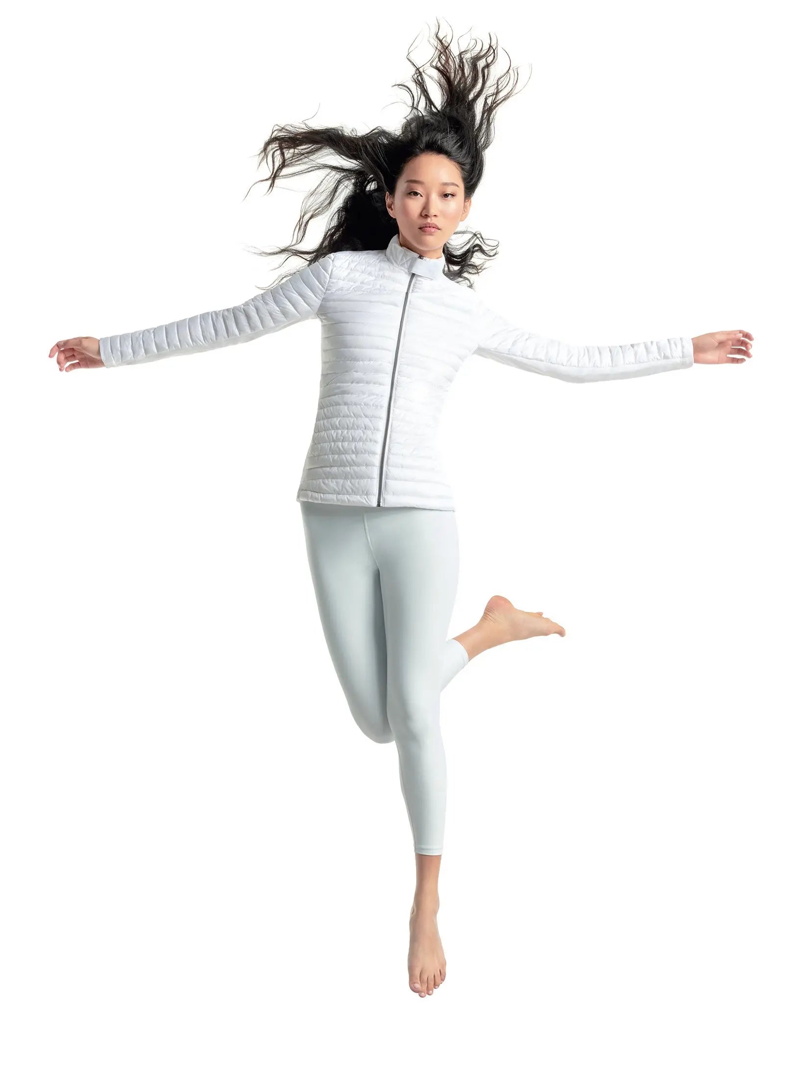 Person wearing a white puffer jacket and leggings on a white background