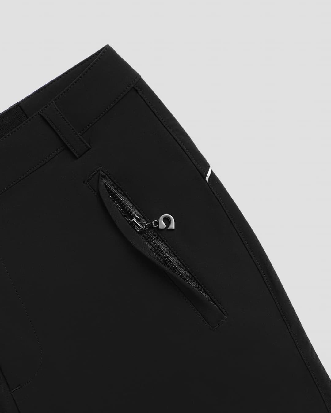 Color:Night Close-up of black athletic leisure Inka pants with a zipper pocket