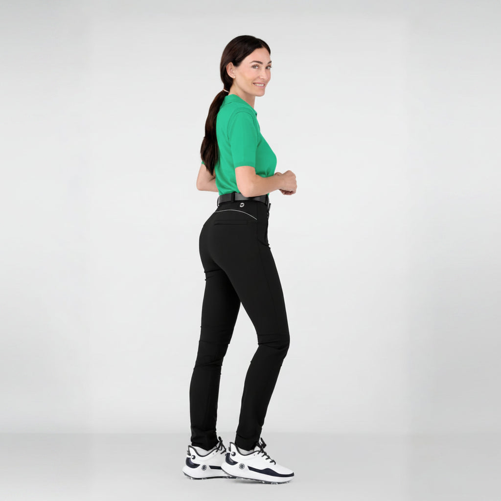Woman wearing a cashmere green shirt and slimming black athletic leisure Inka pants on a white background