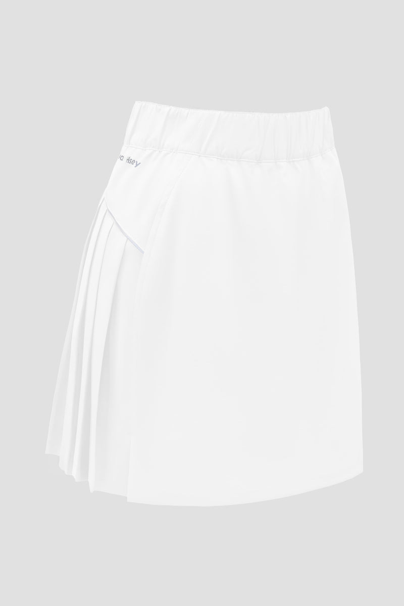 A white athletic skort with a pleated back panel and an elastic waistband