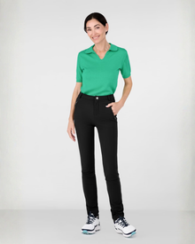 Woman wearing a green cashmere polo shirt and black athletic leisure Inka  pants 
