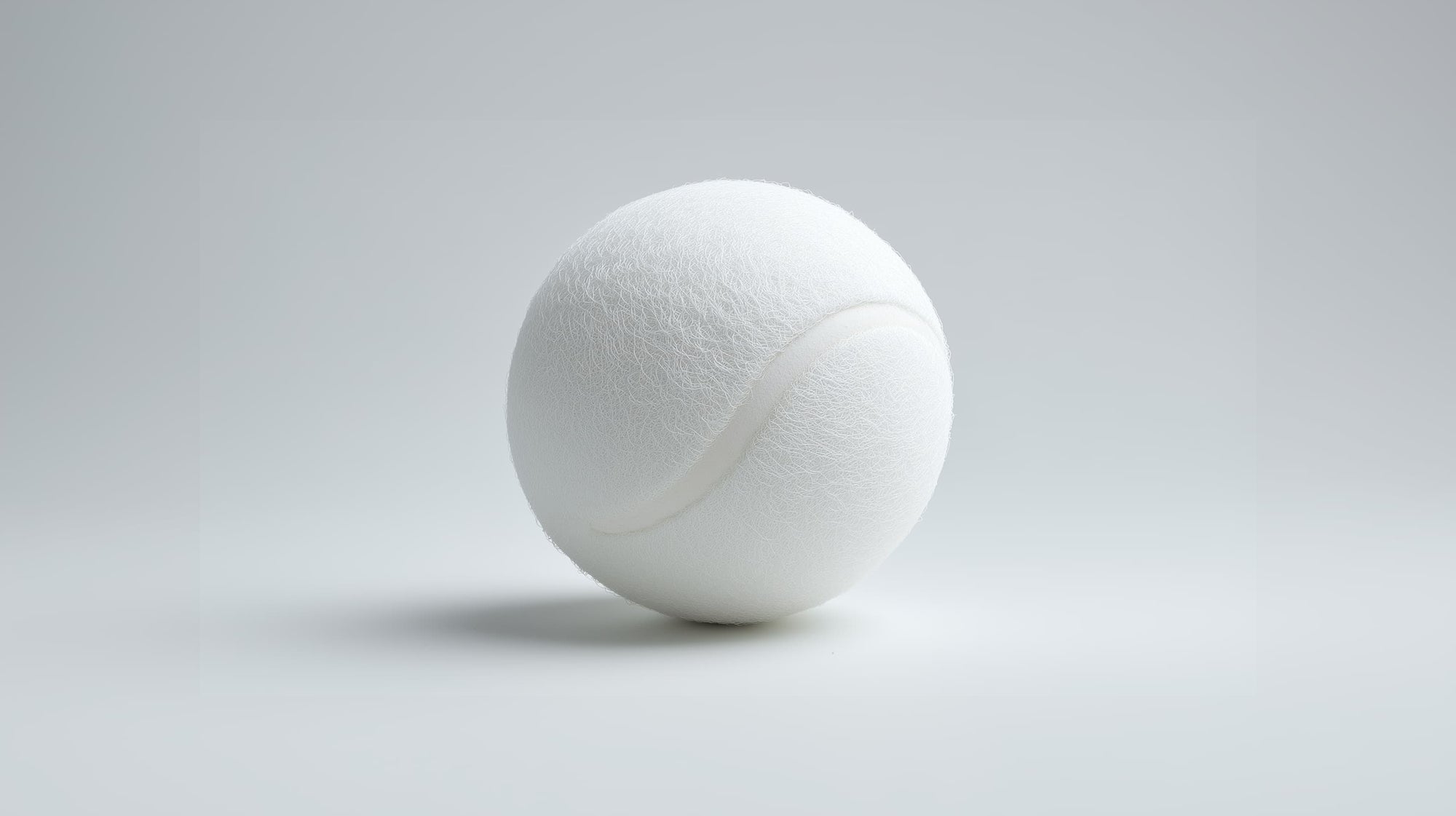White tennis ball on a light grey background